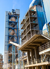 Cement factory. Pipes and compressors, equipment, metalurgy. Modern technologies work at a cement plant. Technological work on the production of cement. Working atmosphere with copy space.