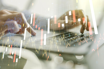 Naklejka premium Abstract creative financial graph with world map and with hands typing on laptop on background, forex and investment concept. Multiexposure