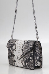 elegant and sophisticated women's handbag made of natural material on a light background