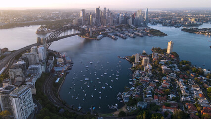 Naklejka premium Aerial view of Sydney City, the Sydney Harbour and Harbour Bridge looking over Lavender Bay, NSW Australia on a sunny early morning in November 2023 