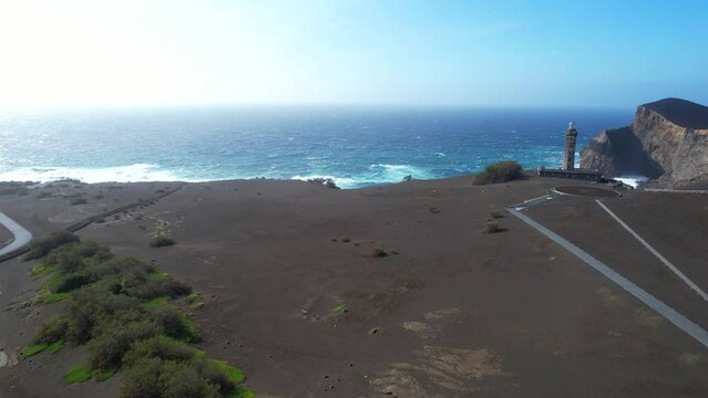 Man contemplating volcanic landscape of Capelinhos, Azores. Aerial ascendant