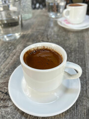 cup of Turkish or greek coffee on wooden table