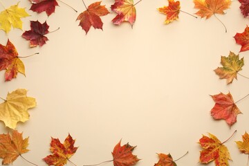 Naklejka na ściany i meble Autumn season. Frame of colorful maple leaves on beige background, top view. Space for text