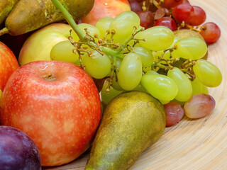 fruits plate with fresh grapes, pears, apples