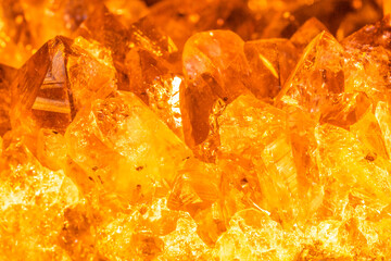 Golden crystal mineral stone. Gems. Mineral crystals in the natural environment. Texture of precious and semiprecious stones. Seamless background with copy space.