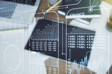 Multi exposure of stats data illustration and modern digital tablet on background, top view, computing and analytics concept