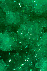 Green crystal mineral stone. Gems. Mineral crystals in the natural environment. Texture of precious and semiprecious stones. Seamless background with copy space colored shiny surface of precious stone