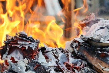 Roaring bonfire with paper illuminated by an intense orange glow