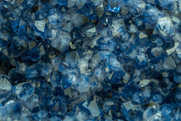 Blue Crystal Mineral Stone. Gems. Mineral crystals in the natural environment. Texture of precious and semiprecious stones. Seamless background with copy space colored shiny surface of precious stones