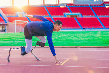 Asian para-athlete with prosthetic blades leg in stadium practicing workout for Paralympic running competition. Amputee sportsman runner practicing running workout. Disabled athlete man sport concept.