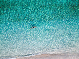 tropical island paradise: woman swimming in the beautiful tropical turquoise ocean at the beach
