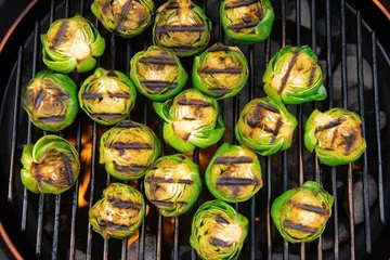 Tuinposter overhead shot of a grill filled with charred brussels sprouts © primopiano