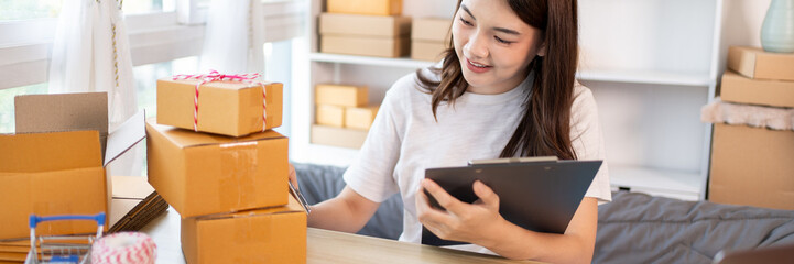 Online selling business, Small business owners are checking inventory in order to prepare them for proper delivery to customers,  Working from Home: Managing E-commerce Operations.