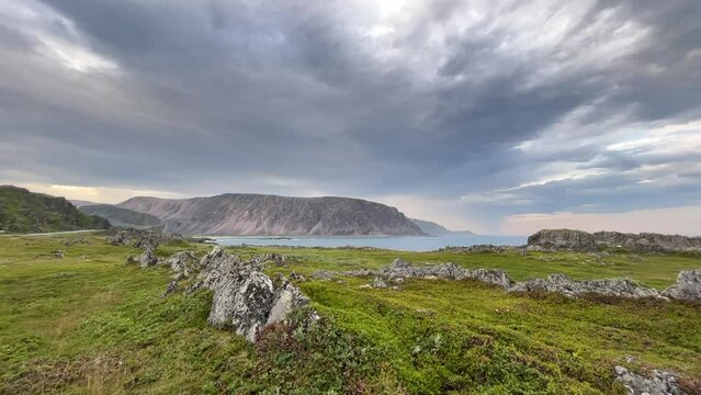 Cloudy evening sky over the rocky shoreline of the Barents Sea, Northern Norway
