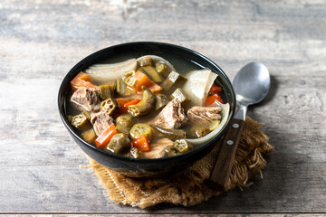 Traditional African okra soup on wooden table