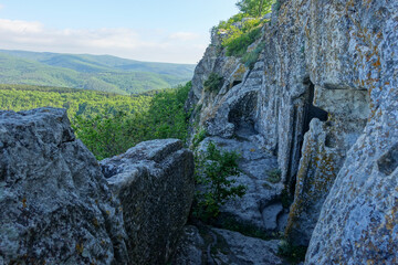 Ancient buildings cave fortress city Mangup-Kale, sunny day. Mountain view from the ancient cave town of Mangup-Kale in the Republic of Crimea, Russia. Bakhchisarai.