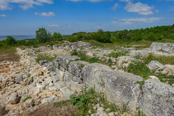 Ancient buildings cave fortress city Mangup-Kale, sunny day. Mountain view from the ancient cave town of Mangup-Kale in the Republic of Crimea, Russia. Bakhchisarai.