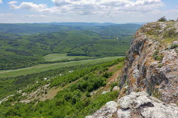 Fototapeta premium Mangup-Kale cave city, sunny day. Mountain view from the ancient cave town of Mangup-Kale in the Republic of Crimea, Russia. Bakhchisarai.