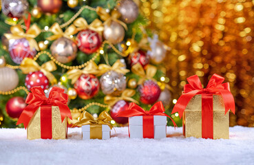 box with gifts and bows on the background of a Christmas tree.