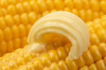 Butter melts on corn cobs.