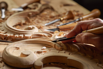 Professional tools on a wooden table in the workshop. Surface covered with sawdust. Carpenter working with tools close-up