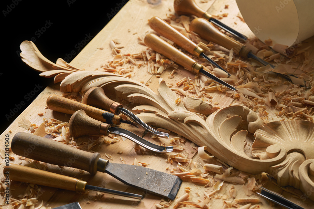 Wall mural Wood carving tools. Carpenters hands use chisel. Senior wood carving professional during work. Man working with woodcarving instrument