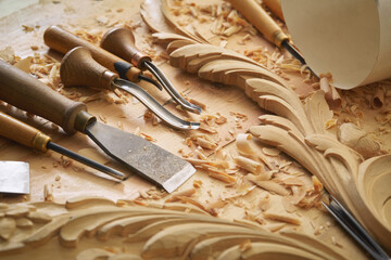 Wood carving tools. Carpenters hands use chisel. Senior wood carving professional during work. Man...