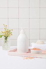 A marble tray feature a pump bottle and a bowl of pink himalayan salt. Pink Himalayan salt is less processed than table salt. Branding mockup design