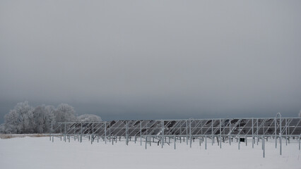 Solar panels in field on a grey cold winter day in rural scenery
