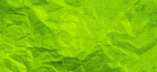Empty bright green colored grunge crumpled crushed paper background.