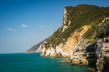 Fototapeta na wymiar Scenic view of majestic cliffs surrounded by blue waters. Portofino, Italy