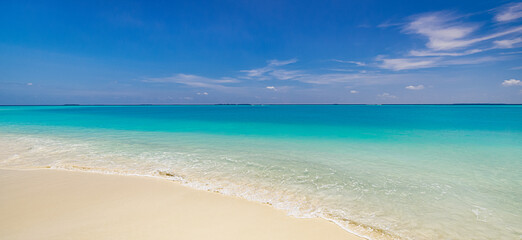 Nature landscape view of beautiful tropical beach and sea in sunny day. Beach waves inspire summer vacation. Nature of tropical Mediterranean beach sunlight. Light sand beach, ocean water sparkles