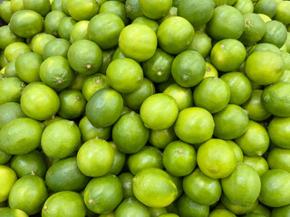 fruit background with fresh green limes in the market