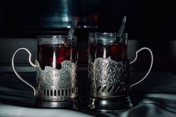 Two glasses of tea in retro teacups on a train. Travel concept.