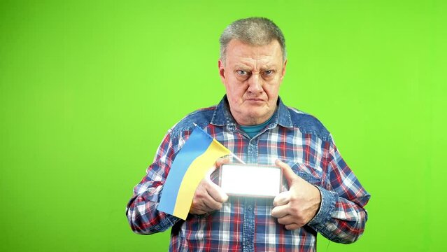Mature man with ukrainian flag gives sos signal Morse code using flashlight.