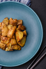 Delicious crispy fried potato wedges with salt, spices and herbs