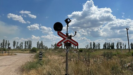 Traffic light and railway sign before railway crossing during the war in Ukraine, The sign and...