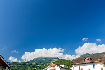 Solo paragliding in the clear blue sky over the mountains, Swiss Alps in Switzerland