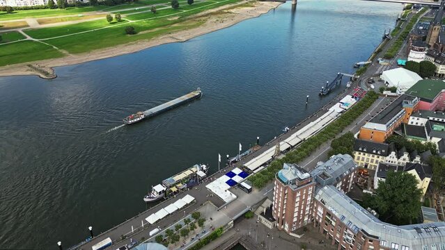 Cargo vessel travelling along the river Rhine, Düsseldorf, Germany. Aerial