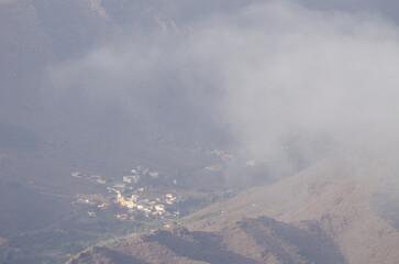 Village of Tasarte in the fog.  La Aldea de San Nicolas. Gran Canaria. Canary Islands. Spain.