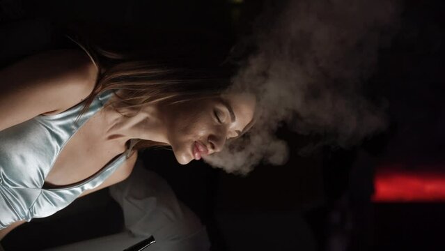 A couple in love smokes a hookah on the terrace of a restaurant. Concept of hookah smoking. Vertical video