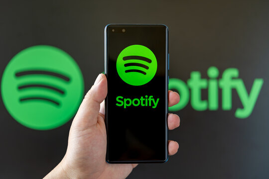 ZHONGSHAN China-July 6,2023:hand holding a mobile with spotify logo at horizontal composition.