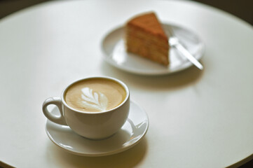 coffee cup latte with cake on the table