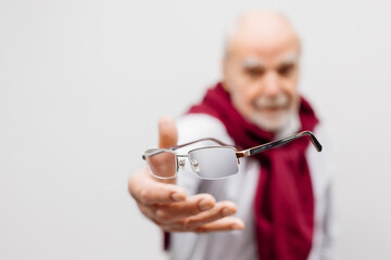 Vision correction and treatment. A mature man throws away his glasses after vision treatment. A...