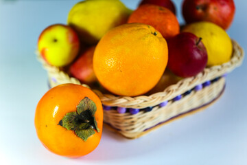 Khaki, pear and apples on a white background