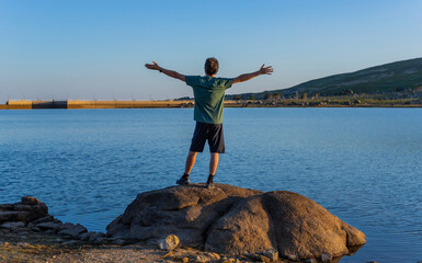 Fototapeta na wymiar Man tourist standing overlooking the lake