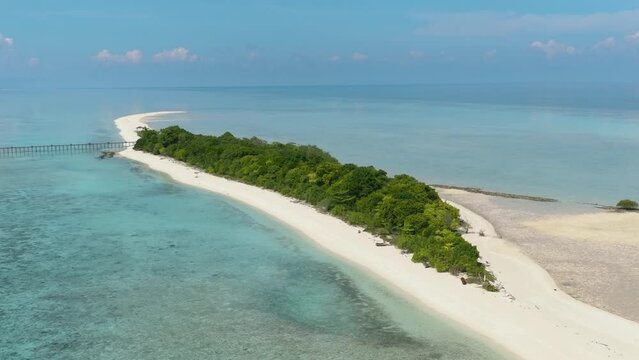 Aerial view of sandy tropical island with a beautiful beach surrounded by a coral reef.Timba Timba islet. Tun Sakaran Marine Park. Borneo, Sabah, Malaysia.