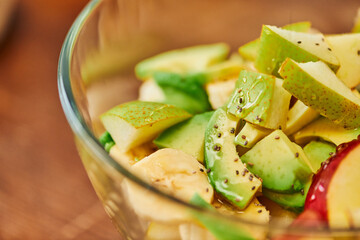 close up view of vegetarian salad with fresh fruits and honey with sesame seeds, plant-based diet