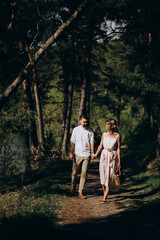 Young couple having a walk in the woods