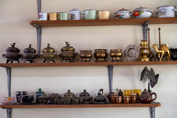 Various decorative iron cups and containers are typical Indonesian decorations